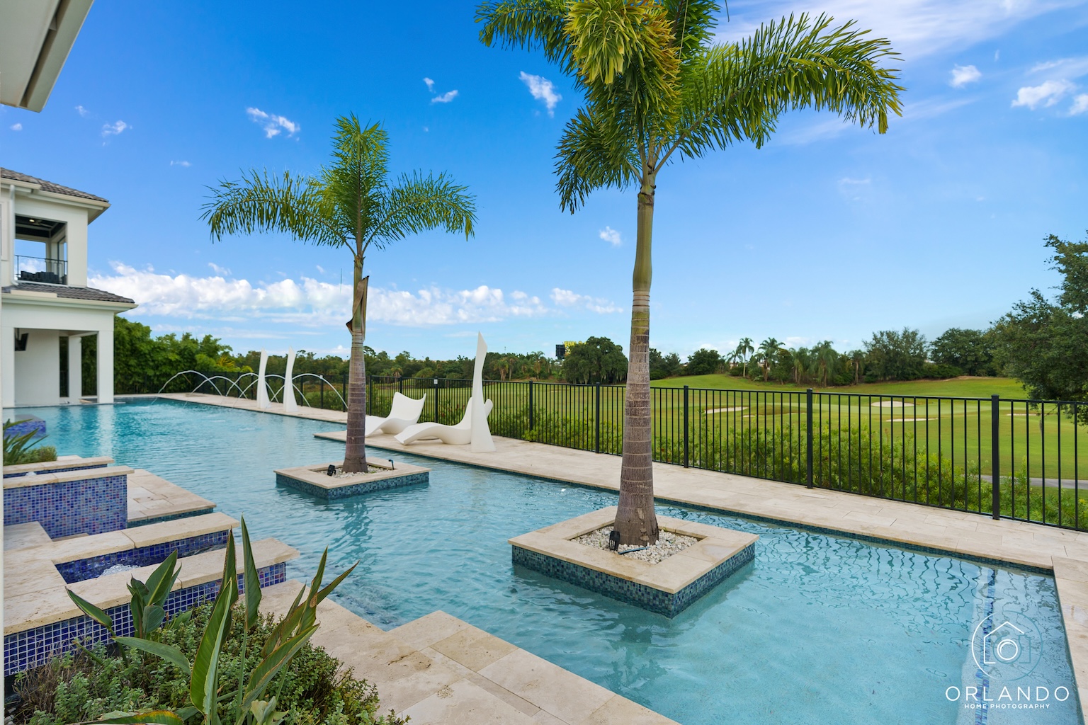 Luxury vacation rental pool with palm trees and golf course view — professional pool photography by Orlando Home Photography