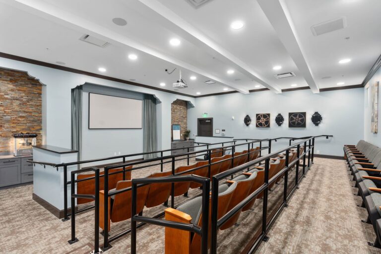 Movie theater with tiered seating at The Grove at Trelago senior living