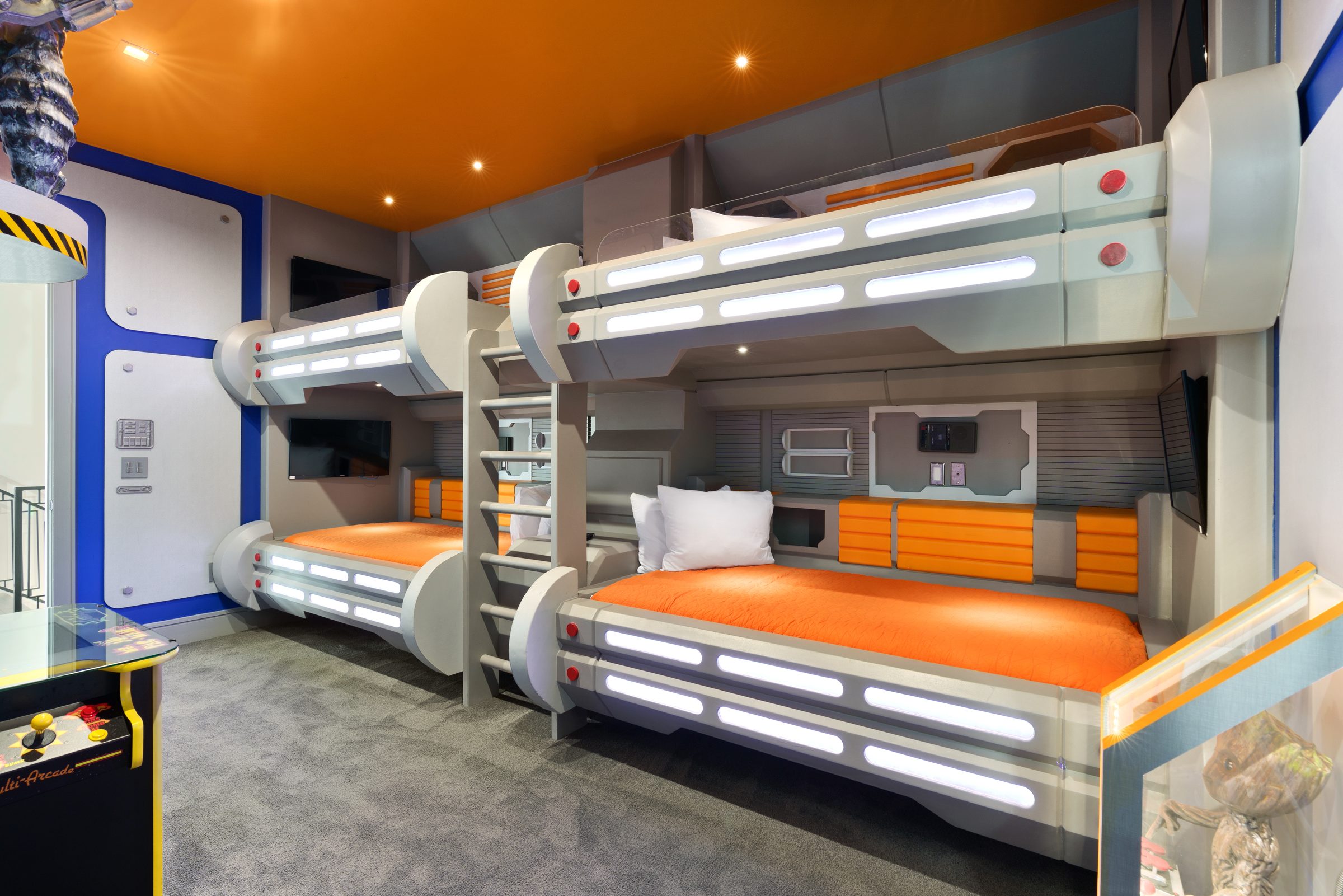Space capsule themed bunk beds with built-in arcade games in a vacation rental — Orlando Home Photography