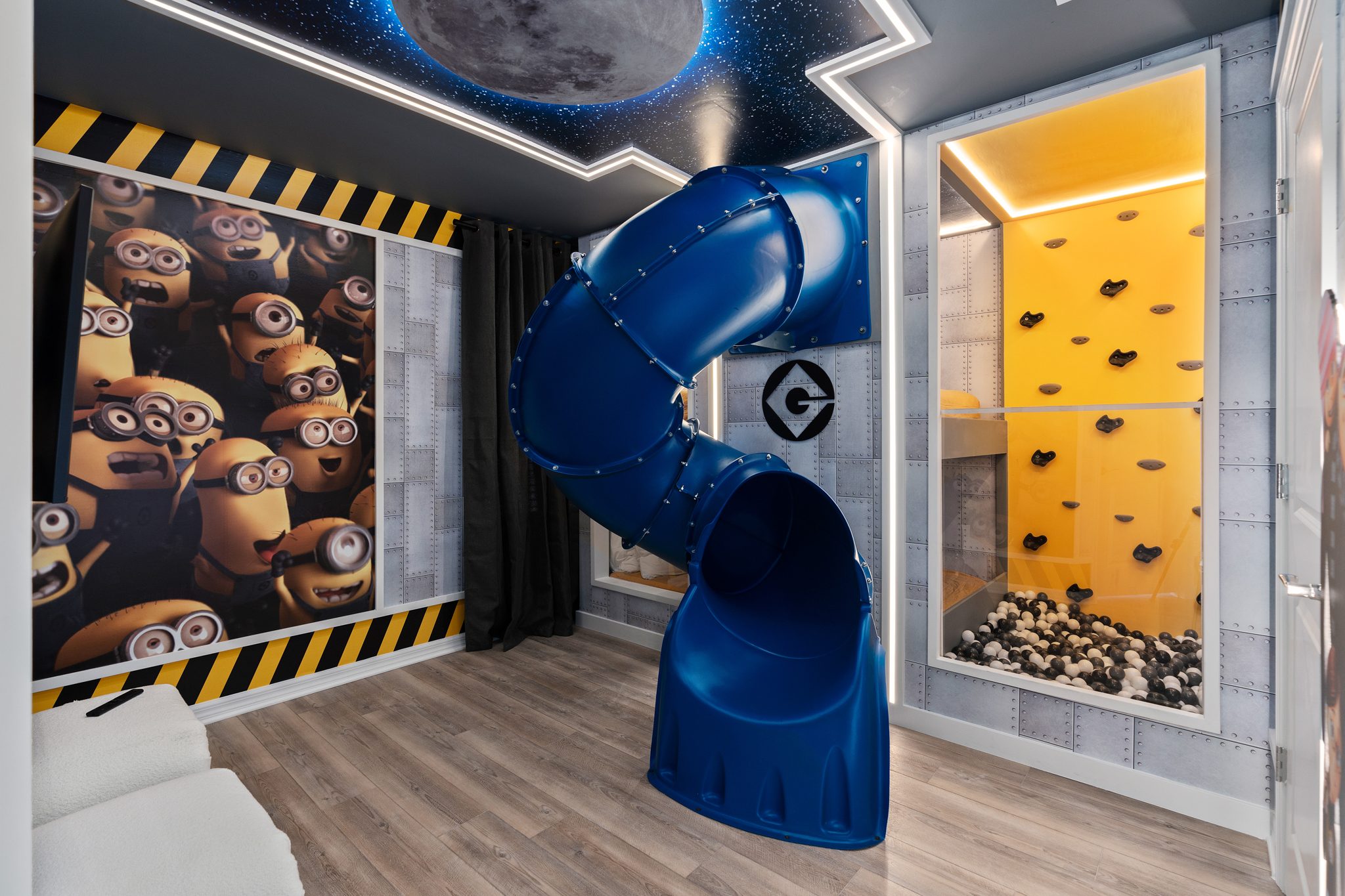Minions themed vacation rental bedroom with full-size tube slide, climbing wall, and ball pit — Orlando Home Photography