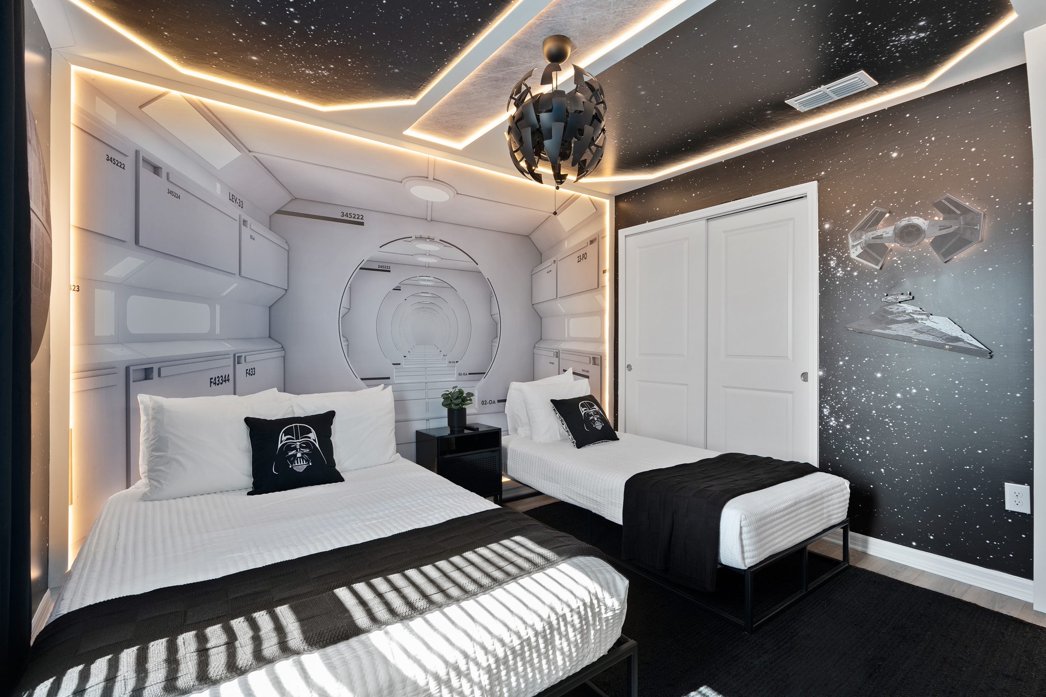 Star Wars themed vacation rental bedroom with galaxy ceiling, custom wall murals, and Darth Vader accent pillows — Orlando Home Photography