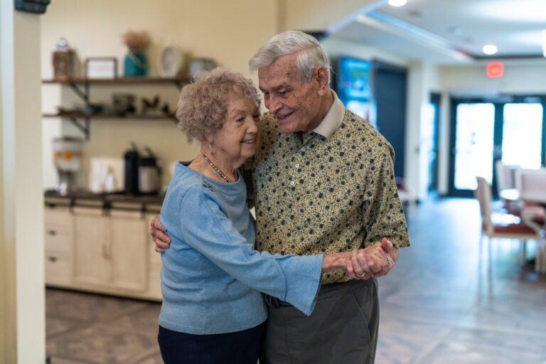 Senior couple dancing together at a senior living community