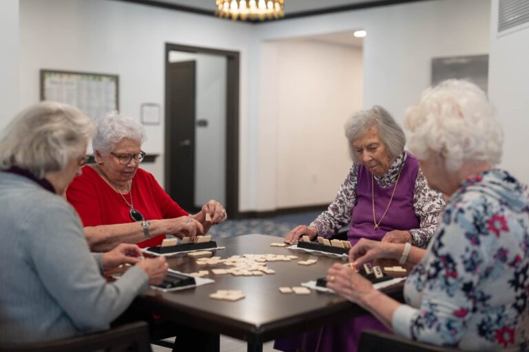 Residents playing a tile game together at a senior living community