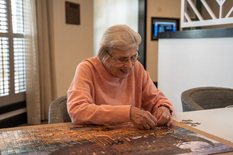 Resident working on a jigsaw puzzle at a senior living community