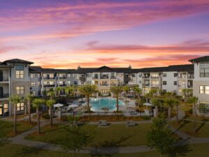 Twilight photo of the resort-style courtyard and pool at Starling at Nocatee senior living community
